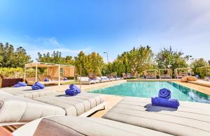 a row of chaise lounges next to a swimming pool at Leonardo Boutique Hotel Mallorca Port Portals - Adults only in Portals Nous