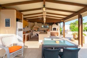 a kitchen and living room with a table and chairs at Muses Beach Villas - Erato in Sitia