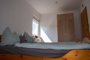 1 dormitorio con 1 cama grande con almohadas azules en FeWo Sabine, en Ebern