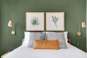 a bedroom with a bed with three pictures on the wall at Tribeca Studio w Pool Roofdeck Gym View NYC-273 in New York +20 photos