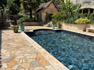 a swimming pool in a yard with a house at Domaine de Beaufort in Saint-Front-de-Pradoux