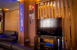 a living room with a large flat screen tv at Chagala Bautino Hotel in Bautino
