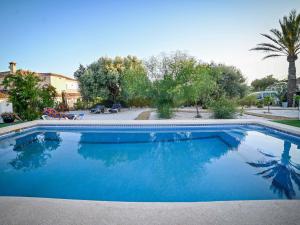 une grande piscine bleue dans une cour dans l'établissement Alojamiento Rural EnClave, à Burjulú