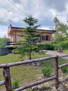 a house with a fence in front of it at Chalet Grazia in Valgiano