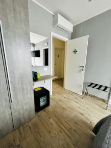 a white room with a room with a table and a door at Marea B&B in Milazzo
