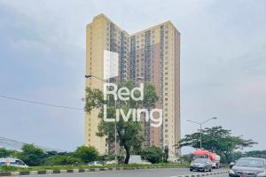 a tall building with a red living sign on it at RedLiving Apartemen Tamansari Panoramic - Anwar Rental in Bandung