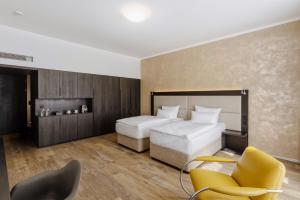 Postel nebo postele na pokoji v ubytování Theresian Hotel
