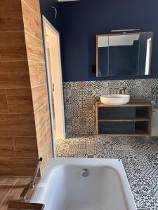 a bathroom with a white tub and a sink at Domy wakacyjne WELLE in Kołczewo +61 photos