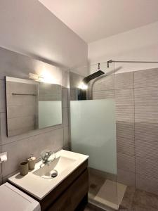 a white bathroom with a sink and a shower at Dafni City Apartment 1 in Athens +17 photos