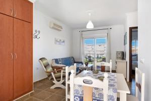 a kitchen and dining room with a table and chairs at Casa Adriana in Conil de la Frontera