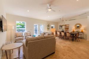 a living room with a couch and a table at Pineapple Palms Resort Style Pool Villa! Sleeps 12 in West Palm Beach