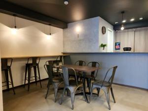 a restaurant with a table and chairs and a counter at Tiz wan hotel in Sumoto