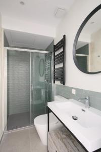 a bathroom with a shower and a sink and a mirror at Charming Palacio Real in Madrid