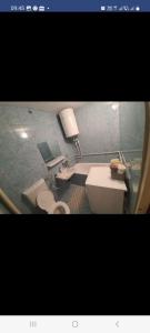 two pictures of a bathroom with a toilet and a sink at garsoniera CxM house in Băile Herculane
