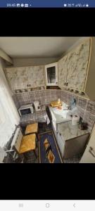 an overhead view of a kitchen with a sink at garsoniera CxM house in Băile Herculane