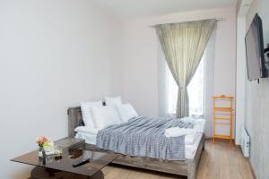 a bedroom with a bed and a table and a window at VN Hotel Vanadzor in Vanadzor