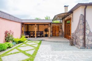 a house with a patio and a building at VN Hotel Vanadzor in Vanadzor