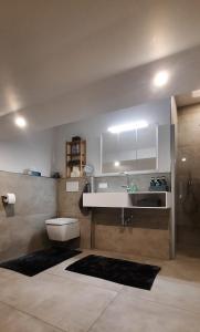 a bathroom with a sink and a toilet at Ferienwohnung Windhagen in Windhagen