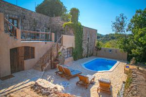 a house with a swimming pool in front of it at Authentic house and traditional breakfast in Vrisnik