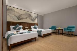 Postelja oz. postelje v sobi nastanitve Kaiserdom Hotel Baiyun Airport-24-hour Airport-Free shuttle bus