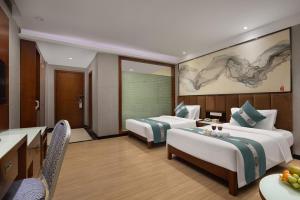 Postelja oz. postelje v sobi nastanitve Kaiserdom Hotel Baiyun Airport-24-hour Airport-Free shuttle bus
