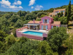 an aerial view of a pink house with a swimming pool at Villa Helios Sea View & Private Pool near Fiskardo in Fiskardo