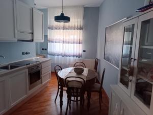 a kitchen with a table and chairs in a room at Carola in Bari +11 photos