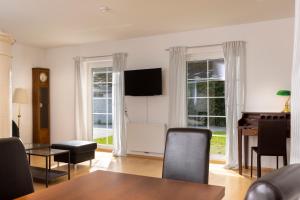 a living room with a table and chairs and windows at Ferienhaus Lienz in Lienz