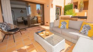 a living room with a couch and a table at Coto Real Thasos 222 in Manilva