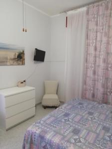 マルツァメミにあるVilla Sarjのベッドルーム1室(ベッド1台、椅子、ドレッサー付)