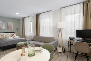 a living room with a bed and a couch at Arbio I Central Apartments Koblenz in Koblenz