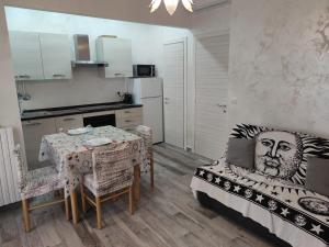 a kitchen and a dining room with a table and chairs at CASA DADO in Rapallo