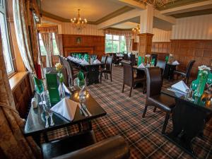 a restaurant with tables and chairs in a room at North Shore Hotel in Skegness
