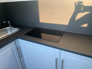a kitchen with a shadow of a person on the counter at Apartment Brussels Airport and NATO OTAN in Machelen +8 photos