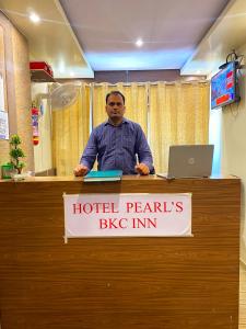 a man is standing at a hotel perils big inn at Hotel Pearl's BKC Inn- Near Trade Centre, Visa Consulate in Mumbai