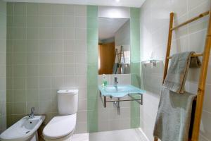a bathroom with a toilet and a sink at Vista Mar in Cabanas de Tavira +18 photos