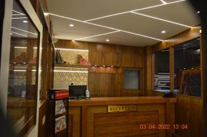 a restaurant with a reception desk in a room at CTC GARDENIA RESIDENCY in Bangalore