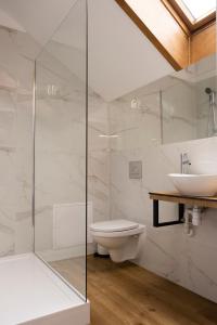 a bathroom with a toilet and a sink at ORKANA House in Olsztyn