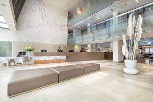 a lobby with a couch in the middle of a room at Valamar Lacroma Dubrovnik Hotel in Dubrovnik