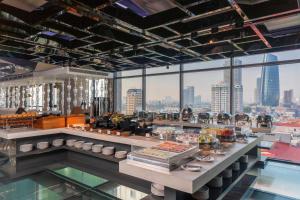 a buffet in a restaurant with a view of a city at New Orient Hotel Da Nang in Danang