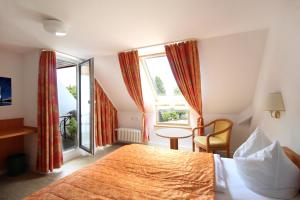 a hotel room with a bed and a window at Hotel Schiff am See in Konstanz