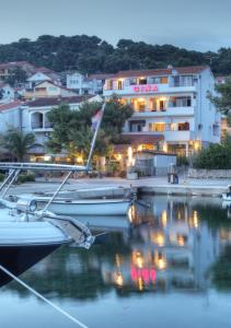 a group of boats docked in a marina at night at Gina Bed & Breakfast in Tisno