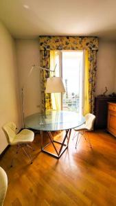 a dining room with a glass table and two chairs at Blu Apartment in Historical Hunbury in Bordighera