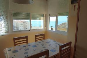 jadalnia ze stołem i widokiem na ocean w obiekcie Estudio Rincon de la Victoria ( Malaga) w mieście Rincón de la Victoria