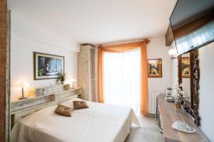 a bedroom with a white bed and a window at Beach House Sveti Jakov 1 in Dubrovnik