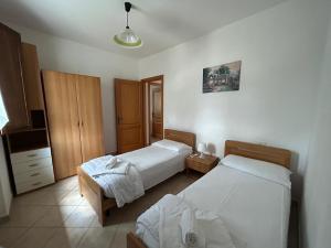 a hotel room with two beds in a room at Residence San Francesco in Pomarance