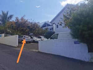an orange cone in a parking lot next to a house at La bulle bleue - Coeur de St Gilles les bains in Filaos