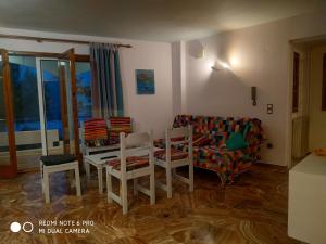 a living room with a couch and a table and chairs at Muses apartments in Eretria