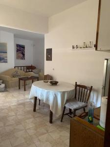 a living room with a table and a couch at Volcano View Nisyros in Mandrákion +15 photos