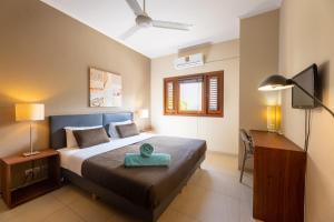 a bedroom with a bed and a desk with a lamp at Spanish Water Apartments in Willemstad